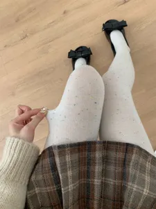 Detail shot of white colorful flecked tights, high elasticity knit fabric showing texture.