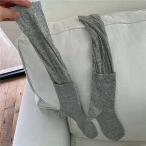 Grey knitted over-the-knee slouch socks, comfortable everyday casual hosiery detail.