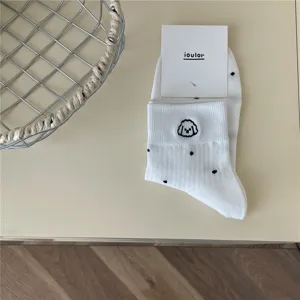 White short socks featuring cute dog embroidery and black polka dots, soft and breathable.