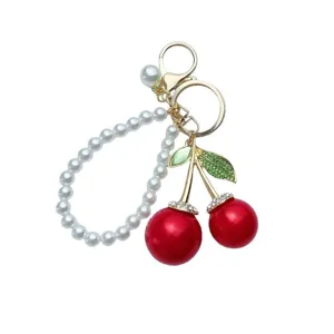 Portachiavi con ciliegia di perle elegante da donna, ciondolo borsa in metallo chic e accessorio.