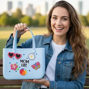 Light blue EVA beach tote bag with cute charms, stylish waterproof perforated handbag for women.