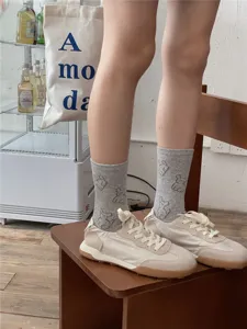 Grey mid-tube socks with cute animal pattern, trendy casual cotton socks for women detail view.
