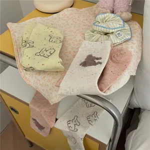 Cute cartoon dog bear pattern mid tube socks detail shot, soft cotton material stylish socks.