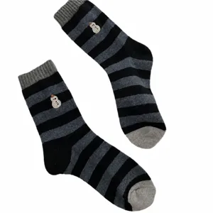 Women winter warm striped wool mid-calf socks featuring cute snowman embroidery design.