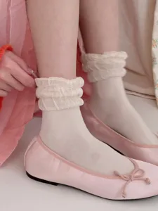 Detailansicht von kurzen Damen-Seidensocken mit Rüschen, kombiniert mit rosa Ballerinas.