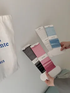 Detailed view of summer sheer dot leg warmers in multiple colors, soft fabric lifestyle shot.