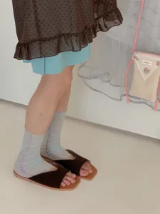 Detail shot of breathable ice silk ruffle socks worn with sandals, soft and comfortable.