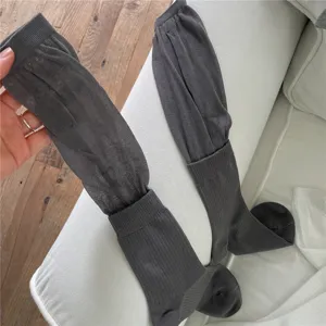 Dark grey long slouch socks with breathable mesh upper and ribbed lower. Detailed fabric view.