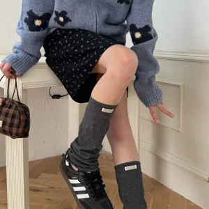 Y2K style grey knitted leg warmers for women, cozy casual slouch socks, trendy streetwear accessories.