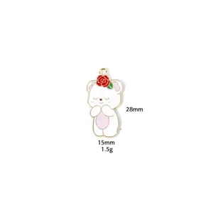 Metal bear charm close-up detail, pink and white enamel pendant for DIY jewelry making.