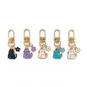 Pearlescent enamel cat keychain with cute flower charm, multi-color metal bag pendant accessory.