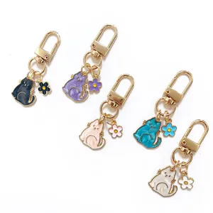 Cute shell pearlescent cartoon cat keychain with mini flower charm, stylish bag pendant.