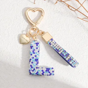 Porte-clés lettre L en strass style européen avec pendentif cœur et cristal bleu brillant.