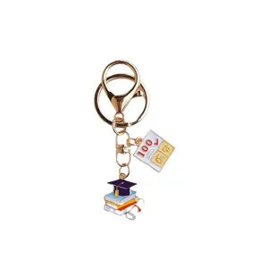 Metal graduation keychain with cap, books, and full marks test pendant for students.