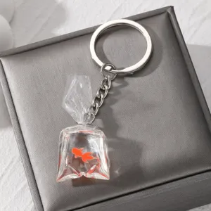 Detailed close-up view of a cute transparent resin goldfish water bag keychain with silver ring.