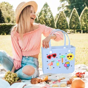 Light blue EVA beach tote bag with cute colorful charms, perfect for summer outdoor vacation.