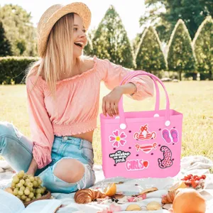 Pink rubber beach tote bag with cute decorative charms, stylish letters and floral pendants for summer.