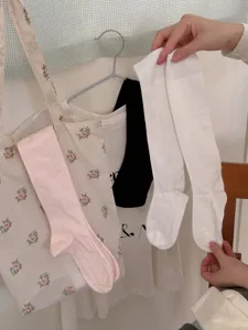 Comfortable white and pink calf socks with vertical stripes, perfect for spring and summer.