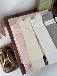 Detailed view of vertical striped calf socks in pink beige white and grey colors.