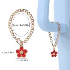 Gold metal cup chain with red enamel smiley flower pendant, cute water bottle charm accessory.