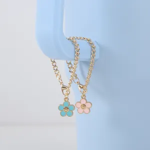 Charming gold-tone thick chain with colorful enamel smiley flower pendants for cups and bags.