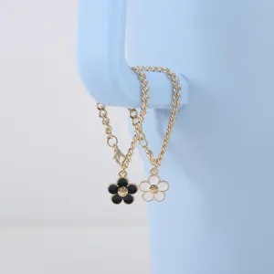 Cross-border minimalist smile flower cup chain with black and white enamel pendant.