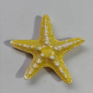 Yellow starfish detail shot, ocean series bag charm accessory showing texture and relief design.