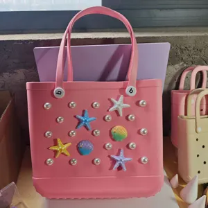 Pink rubber beach tote bag with pearl and sea star charms, waterproof hole bag design.