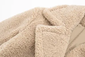 Cozy oversized teddy shearling fleece winter coat featuring wide lapel and warm lining.