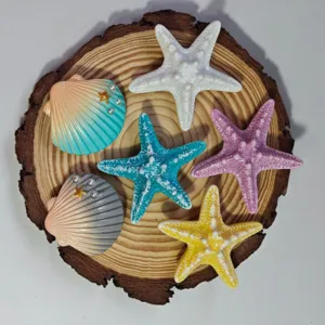 Close-up detail view of colorful ocean starfish and seashell bag charm buttons for decoration.