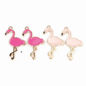 Close-up detail of cute flamingo alloy enamel charms, perfect for DIY jewelry making accessories.
