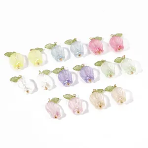 Colorful DIY tulip flower pendants with green leaves and gold loops for handmade jewelry crafting.