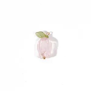 Detailed shot of a delicate pink flower pendant with green leaf, handmade DIY jewelry charm.