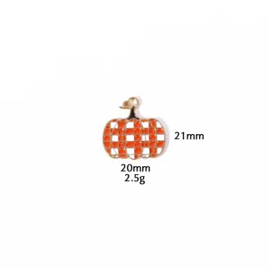 Close-up of orange and white checkered pumpkin enamel pendant charm, detailed zinc alloy view.