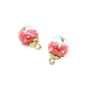 DIY glass ball charm pendants with pink star glitter inside and gold alloy caps for jewelry.