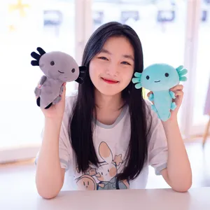 Cute axolotl plush toy detail view, soft stuffed doll in grey and blue holding by model.