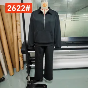 Black half-zip sweatshirt and wide leg trousers lounge set, casual two piece apparel outfit.