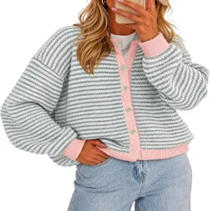 Detailed shot of striped knit cardigan with pink trim, button closure and cozy texture.