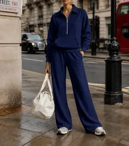 Deep blue quarter-zip sweatshirt and wide leg lounge pants two piece set closeup.