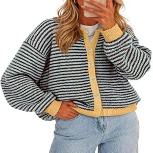 Close-up view of blue and brown striped knitted cardigan with yellow trim and chic buttons.