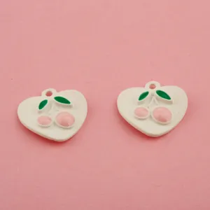 Detail view of DIY heart cherry enamel alloy charms for handmade jewelry bracelets keychains.