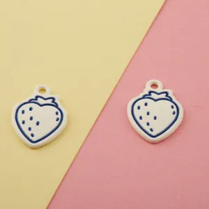 Close-up of white and blue strawberry alloy charms, perfect for DIY jewelry and keychains.
