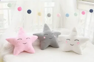 Cute star plush pillow detail showing soft fabric and embroidery face design in nursery decor.