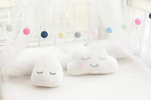Cute cloud and raindrop plush pillows with string lights for kids room decor detail view.