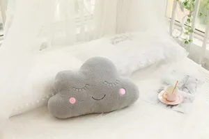Gray plush cloud pillow with cute sleeping face embroidery, soft sofa cushion for kids room decor.