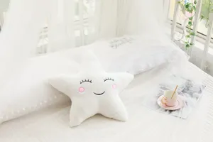 White star plush pillow detail shot, soft cushion for kids room sofa and cozy bedroom decor.