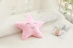 Cute pink star plush pillow, soft stuffed cushion for sofa or children bedroom decor.