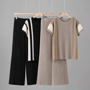 Close-up of ribbed knit short sleeve top and wide leg pants set, detailed contrast color stripes.