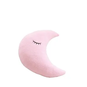 Pink crescent moon plush pillow with cute sleeping eyes embroidery, soft kids room decor.