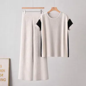 Casual knit set featuring a colorblock short sleeve top and wide leg pants for women.